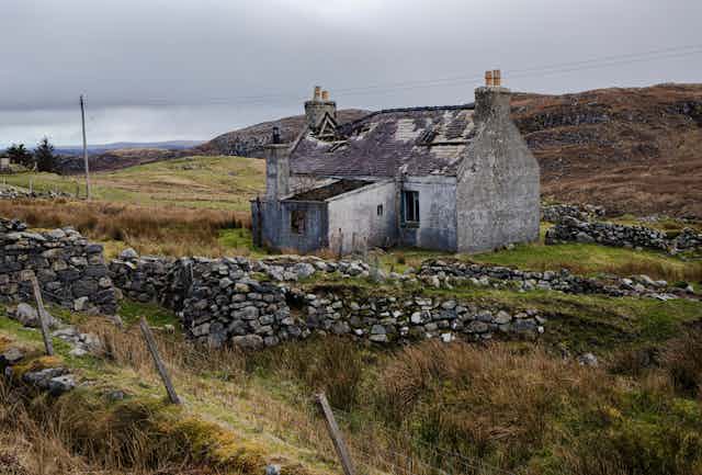 An abandoned, unmaintained house in a field in rural Scotland