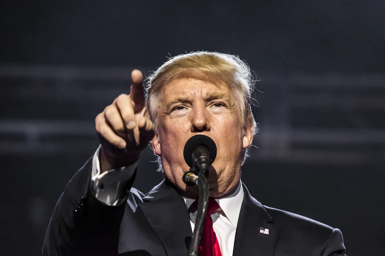 A man points at the camera.