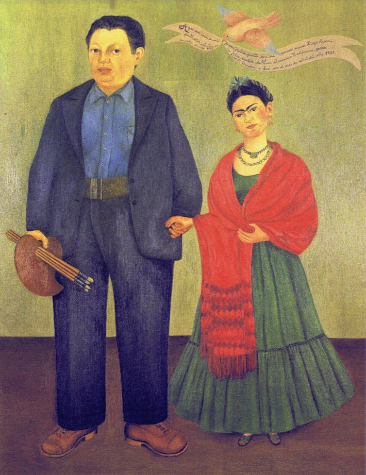 A painting of a large man in a blue suit holding his palette and brushes and a woman in a red shawl and a green dress.
