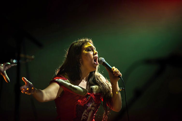 A woman seen singing.