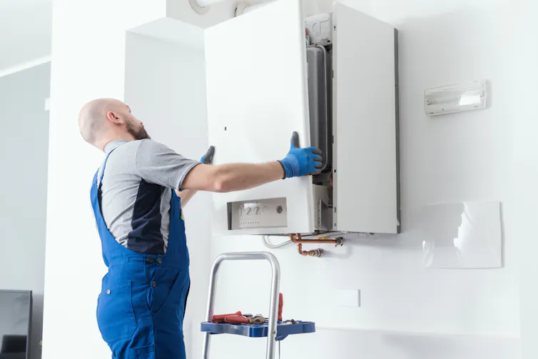 An engineer installing a gas boiler.