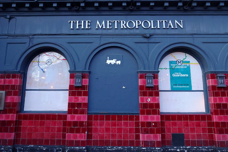 Outdoor red tiles on a pub wall.