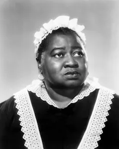 Black actress wearing a maid's outfit.