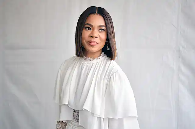 Portrait of Black woman wearing white clothing.