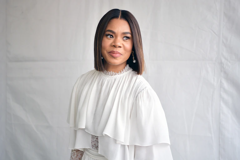 Portrait of Black woman wearing white clothing.
