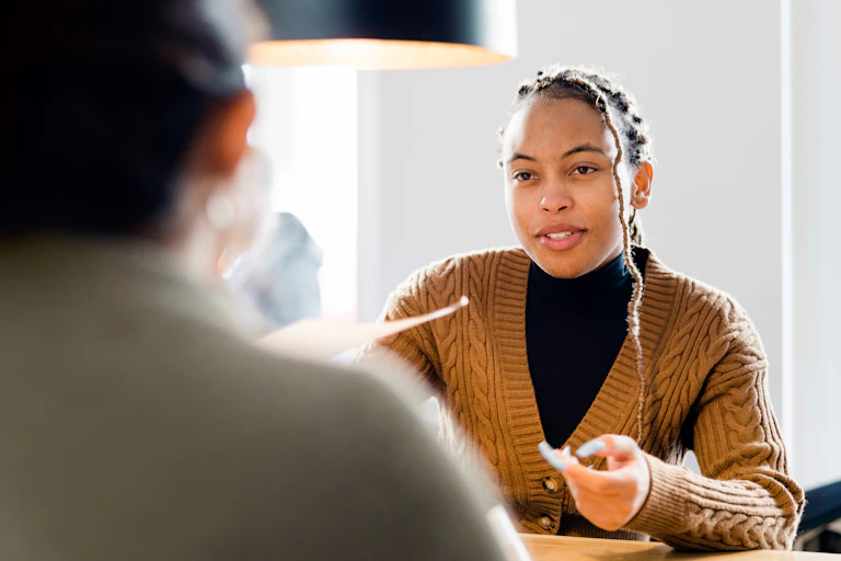 Young woman holds paper in interview or other professional setting