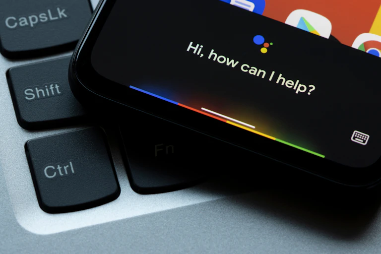 A smartphone displaying the words: how can I help