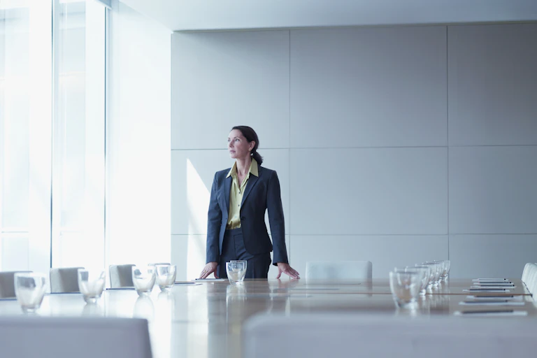 Businesswoman standing alone in conference room