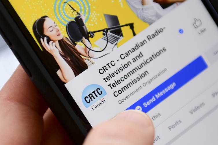 A cell phone displaying the Facebook page of the Canadian Radio-television and Telecommunications Commission