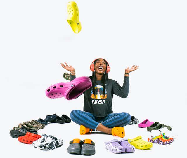 A woman surrounded by Crocs