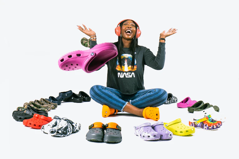 A woman surrounded by Crocs