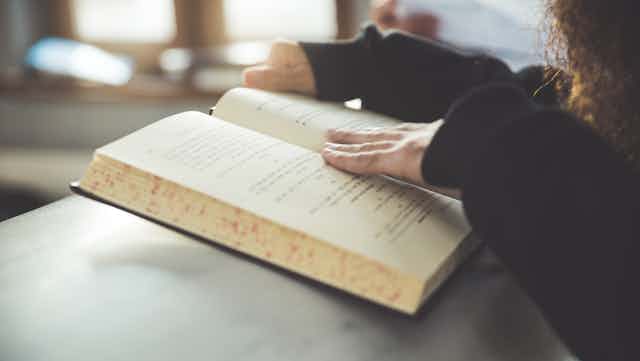A woman reads a Jewish holy book