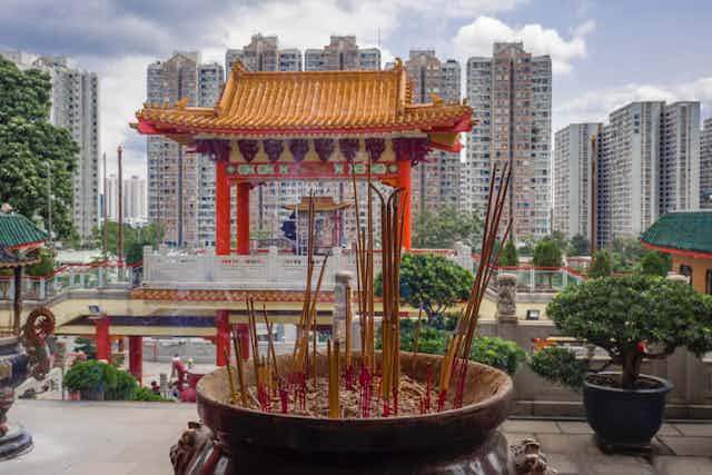 A temple in front of a modern city.