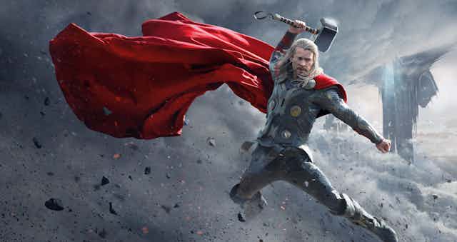 The red-caped Norse god Thor with his hammer held aloft.