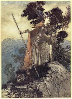 The valkyrie Brunhilde dressed in a cape, breast armour and a helmet standing on a rock.