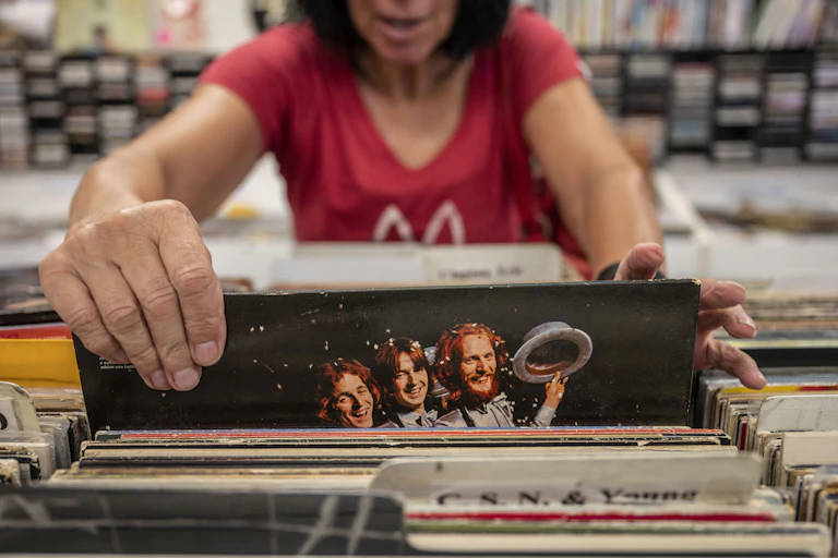 Woman browses at a record store.