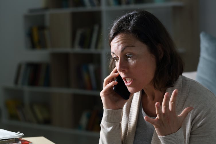 Angry woman speaking on a smart phone