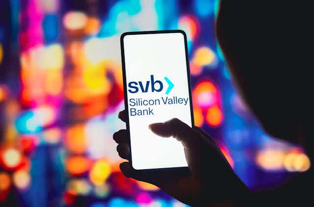 In this photo illustration, the Silicon Valley Bank (SVB) logo is displayed on a smartphone screen.