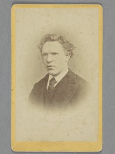 A faded portrait of a young man in a suit.