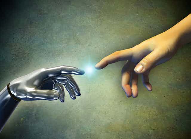 An android hand reaches out to touch a human hand.