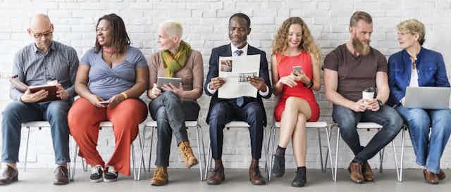 Diverse Group of People Community Togetherness Technology Sitting Concept, newspapers, news, reading, talking, understanding.