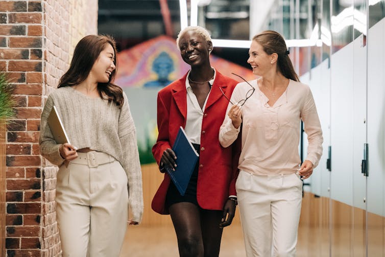 Three women walking at work.