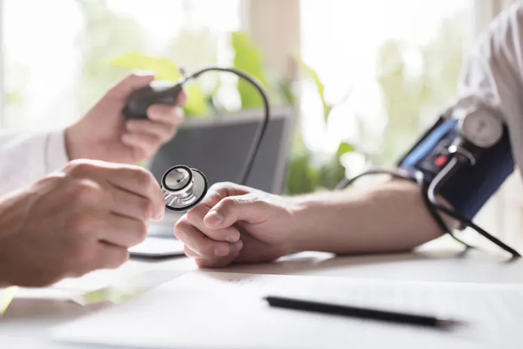 A doctor taking a patient's blood pressure.