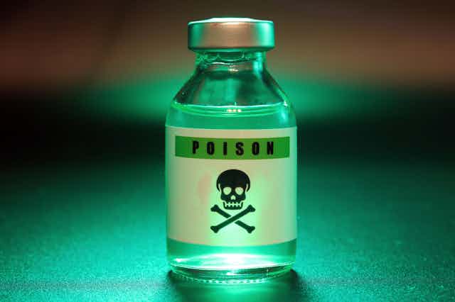 Glass vial with a label inscribed "POISON" over a skull and crossbones