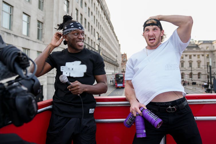 KSI and Logan Paul at a promotional shoot for Prime on top of a bus.