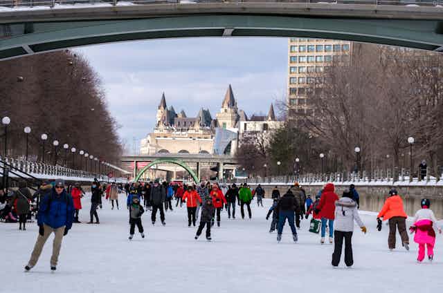 A large ice skating area with people skating.