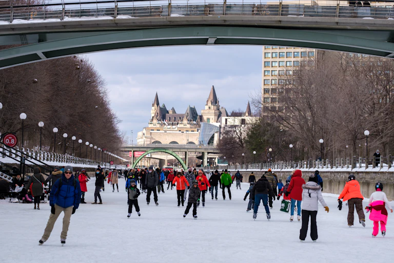 A large ice skating area with people skating.