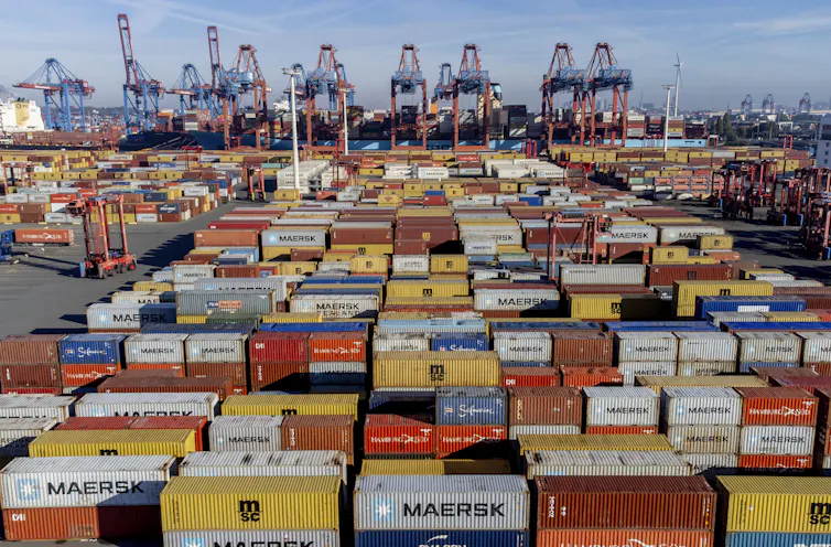 A harbour filled with shipping containers in a variety of colours