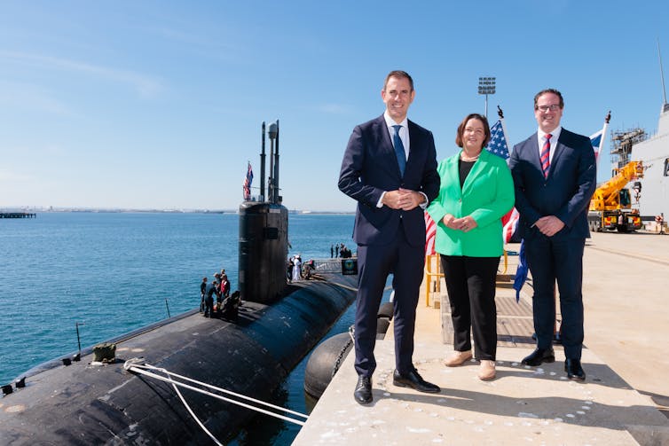Defence Minister Richard Marles stands in front of a sub,