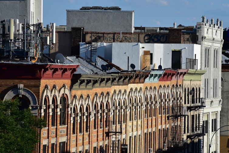 The top of a row of buildings in New York.