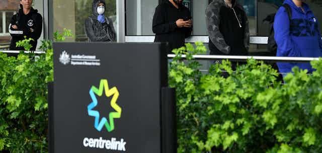 People queuing outside a Centrelink office