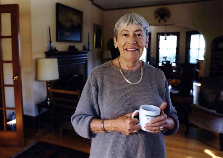 A woman holding a cup of tea.