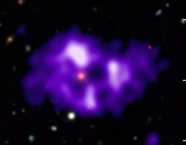 Blurry purple irregular shape with white patches against a dark background