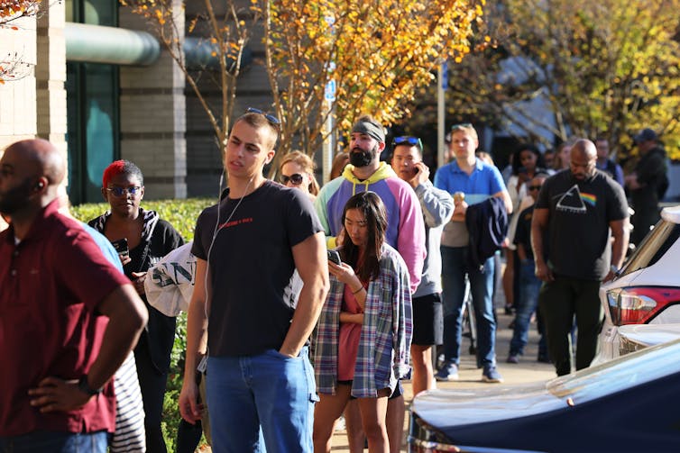 Long line of people standing outside waiting to vote