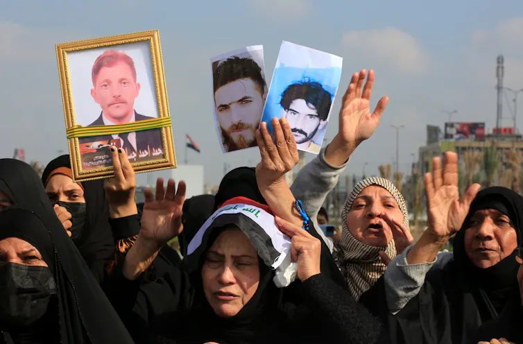 Women protest detained relatives in Baghdad.
