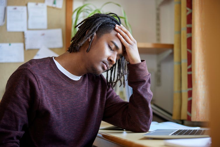 A young man appears stressed.