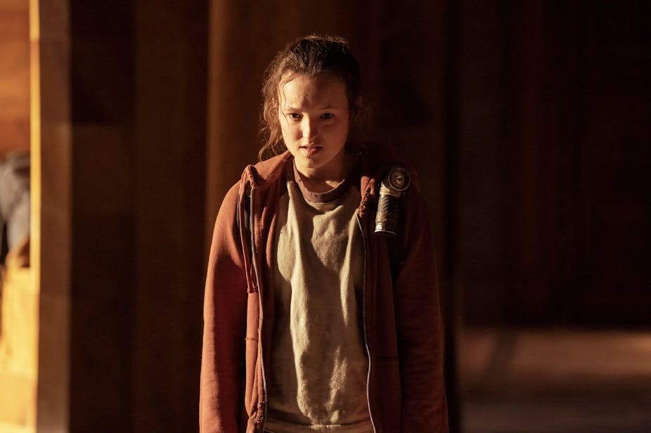 A photo of Bella Ramsey, playing the character Ellie from an episode of the TV series The Last of Us.