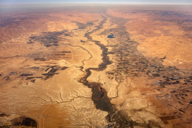 Aerial view of river through dry land