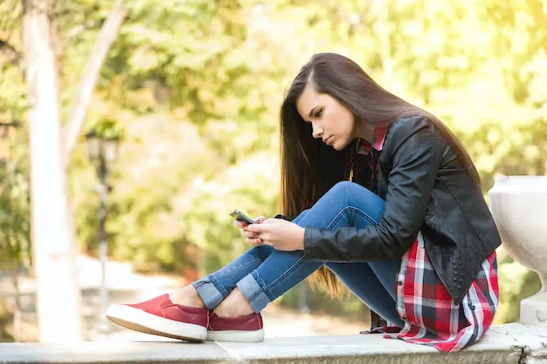 perempuan sedang menggunakan smartphone