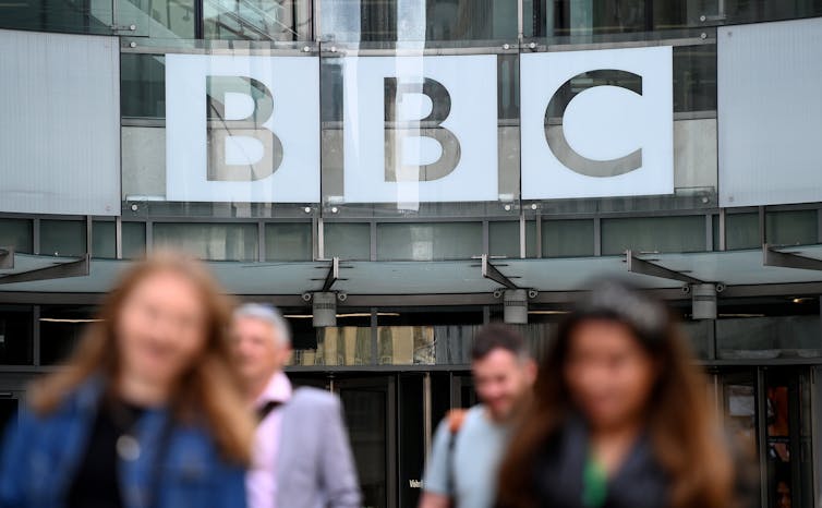 BBC staff walking out of the BBC's London headquarters.