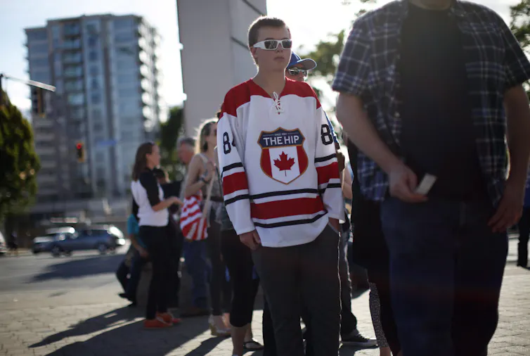 A person in a hockey jersey that says 'The Hip'
