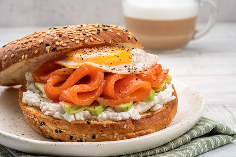 bagel with eggs, salmon, avocado inside