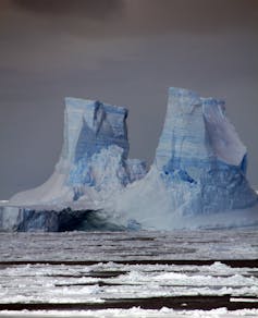 East Antarctic iceberg towers in the background, with meltwater in the foreground