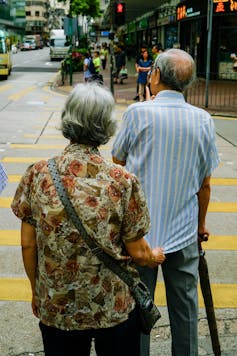 Old man and woman crossing the road