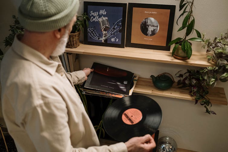 Old man playing records