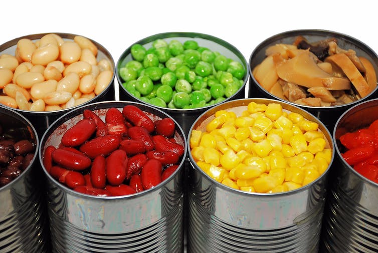 An assortment of canned vegetables, including red kidney beans, peas, and sweetcorn.